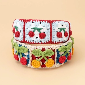 Detail of handmade crochet hair clip with 3D cherry and citrus patterns in granny square style