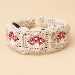 Handmade knitted headband featuring red mushroom embroidery on beige crochet cotton fabric