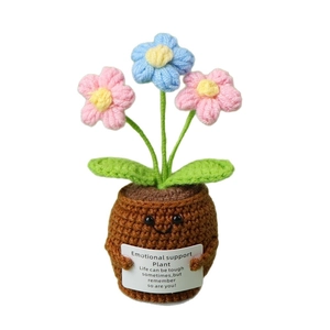 Handmade crochet emotional support plant with smiling face pot and vibrant colorful flowers
