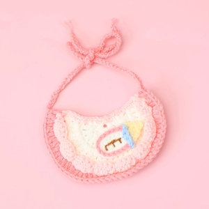 Handmade crochet cat bib with pink floral lace and a cute knitted milk bottle decoration
