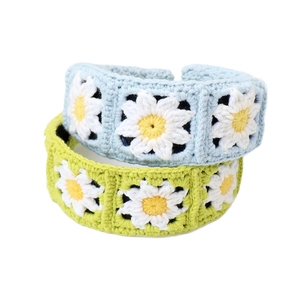 Handmade knitted daisy flower headband in light blue and green colors for women