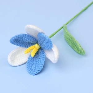 Macro detail of hand-knitted blue and white tulip with soft cotton yarn texture