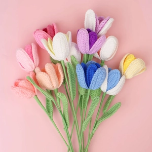 Handmade crochet tulip bouquet with vibrant knitted flowers on a pink background