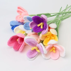 Close-up of hand-knitted crochet tulips with intricate yarn textures in vibrant colors