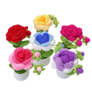 Handmade crochet rose flower potted plants in various colors with white ceramic base