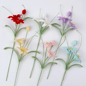 Detailed macro view of handmade crochet zephyrlanthes lilies in six vibrant yarn colors