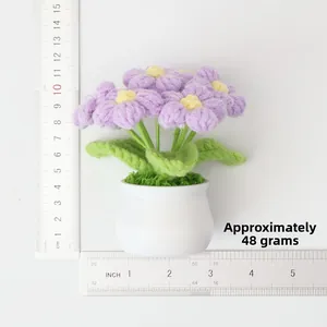Detail of handmade purple crochet potted flower weighing 48g with measurement scale