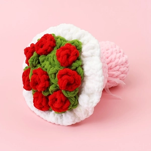 Detailed close-up of handmade crochet red rose bouquet with soft bulky yarn wrapping