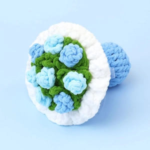 Close-up of hand-crocheted sunflower bouquet with blue yarn flowers and white ruffle edges