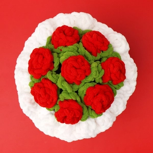 Detailed top view of a handmade crochet bouquet with red roses and white fluffy trim