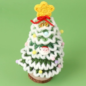 Detail of hand-knitted mini Christmas tree with colorful pompoms and wooden base