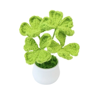 Handmade crochet four-leaf clover potted plant in a white ceramic pot for home decor