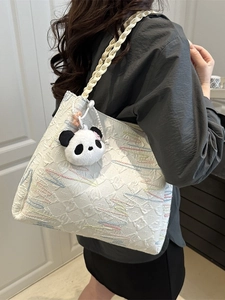 White textured canvas tote bag with colorful embroidery and a cute panda pendant charm