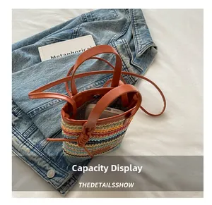 Boho woven bucket bag showing interior space with a smartphone for size reference