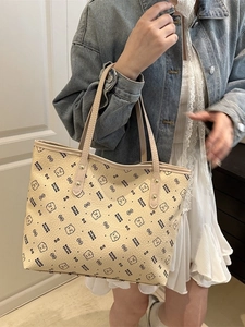 Large cream tote bag with cartoon bear print and shoulder straps for casual commuting