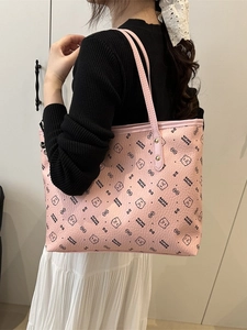 Pink large capacity tote bag with bear print shown on shoulder for daily commute