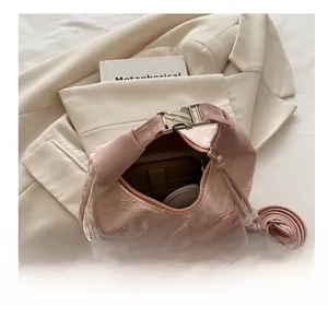 Internal capacity of pink floral jacquard crossbody bag with adjustable strap