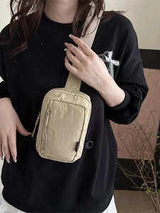 Minimalist beige nylon crossbody chest bag with sports design and zipper pockets