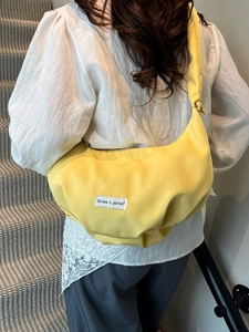 Versatile yellow pleated crescent crossbody bag with adjustable wide shoulder strap for women