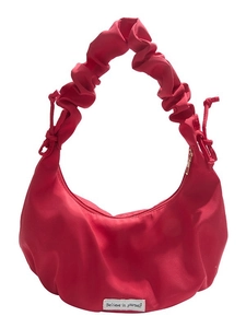 Red hobo crossbody bag with pleated strap and 'Believe in yourself' label detail