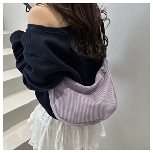 Detailed texture of lavender corduroy hobo bag showing the soft ribbed fabric and strap