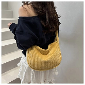 Close-up of yellow corduroy texture on this trendy crescent hobo shoulder bag for women