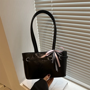 Retro black faux leather shoulder tote bag with a decorative pink ribbon and silver buckle