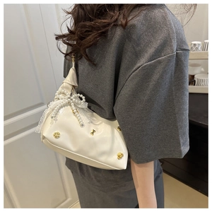 White shoulder bag featuring pearl bow, lace trim and elegant gold buckle detail