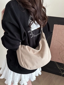 Large beige corduroy crescent shoulder bag with knit strap for casual commute