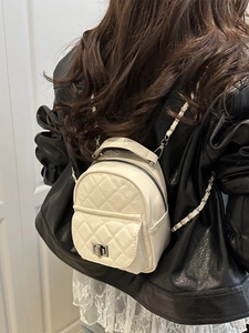 Chic white quilted mini backpack for women featuring silver turn-lock and chain straps