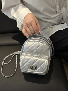 Quilted silver metallic mini backpack with chain strap and twist-lock pocket