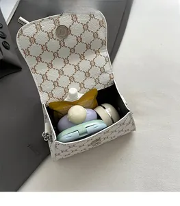 Detail showing the spacious interior of the white chain pattern mini square handbag
