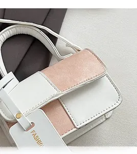 Detailed close-up of textured faux leather stitching and the FASHION label on a mini bag