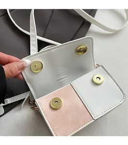 Detail view of mini crossbody bag with dual magnetic closures and inner pockets