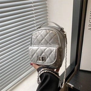 Silver quilted mini backpack and crossbody bag with chain strap and turn-lock closure
