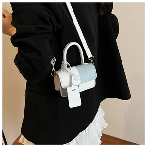 Detailed side view of pink and blue mini crossbody bag with fashion tag on model