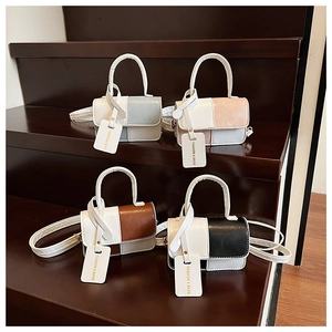 Collection of contrast color square bags in four stylish colorways on wooden steps