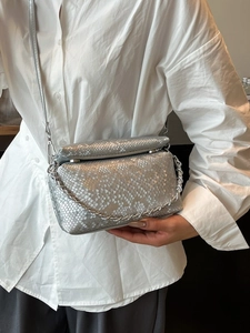 Zilveren crossbodytas met slangenleerpatroon, metalen ketting en minimalistisch design