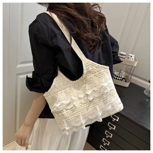 Detailed view of white floral lace tote bag featuring multi-layer ruffled hem design
