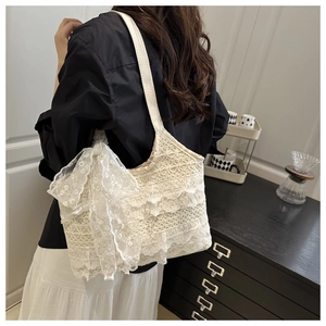 Detailed view of white floral lace tote bag featuring elegant layered ruffles and bow