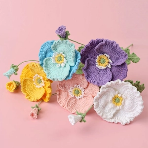 Handmade crochet poppy flower bouquet in vibrant colors with knitted green stems