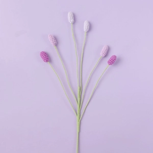 Detailed macro view of 6-head hand-knitted lavender flower with purple crochet texture
