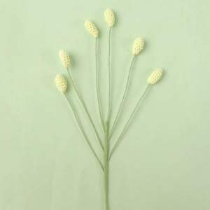 Detail of six handcrafted crochet yellow flower buds with soft green knitted stems