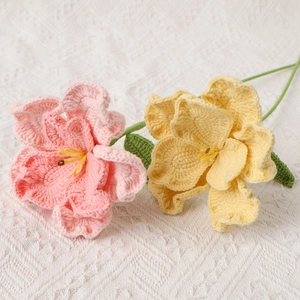Handmade crochet lisianthus flowers in pink and yellow with green leaves and stems