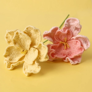 Macro shot of handmade crochet bellflower petals in pink and yellow colors