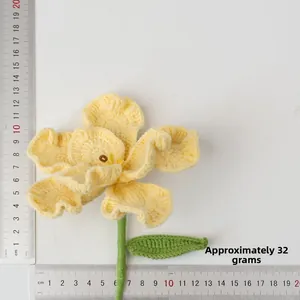 Macro shot of handmade crochet bellflower with steel ruler for dimension reference