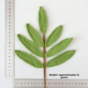Detailed knit olive branch with handmade green leaves and scale showing size and weight