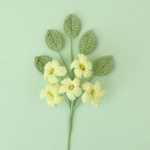 Close-up of handmade crochet flowers with five yellow petals and green leaves on a stem