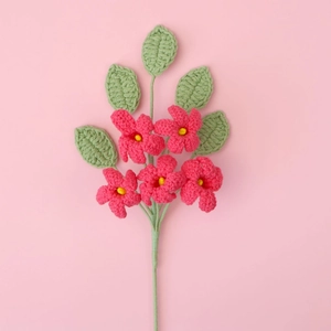 Close-up of handmade crochet pink jasmine bouquet with five heads and green leaves
