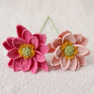 Detail of handmade crochet lotus flowers with pink petals and green yarn stems